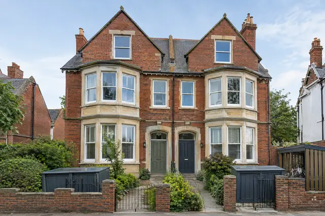 Large Victorian semi-detached villa converted into flats with separate entrances and bin store