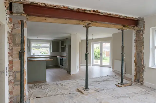 Load-bearing wall removed with a new steel beam supported on temporary props